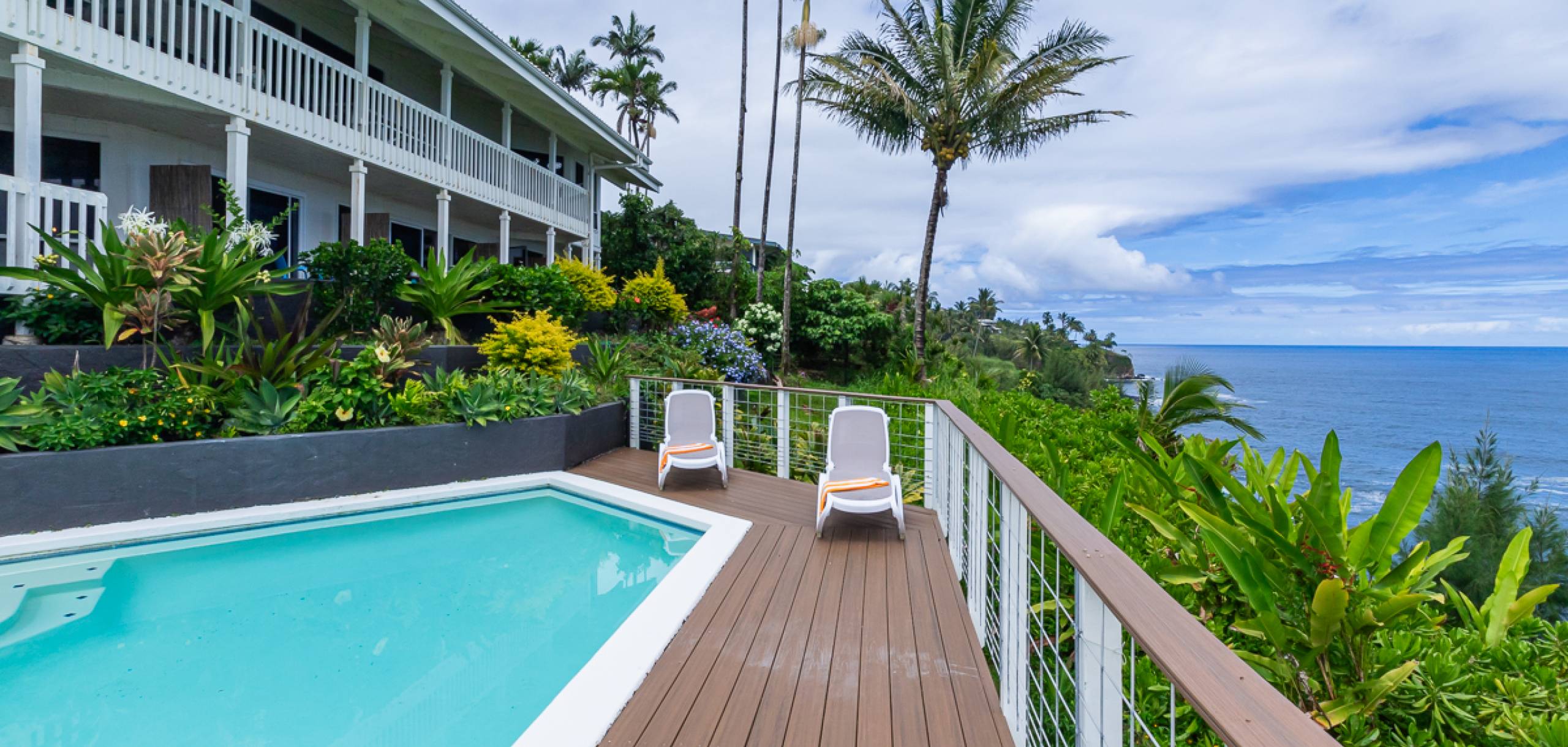 Oceanfront Lodging with pool and lounge chairs